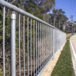 Uni-Fit vertical bar handrail barrier installed along roadside pedestrian path