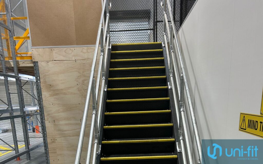 Industrial metal staircase with yellow safety edges